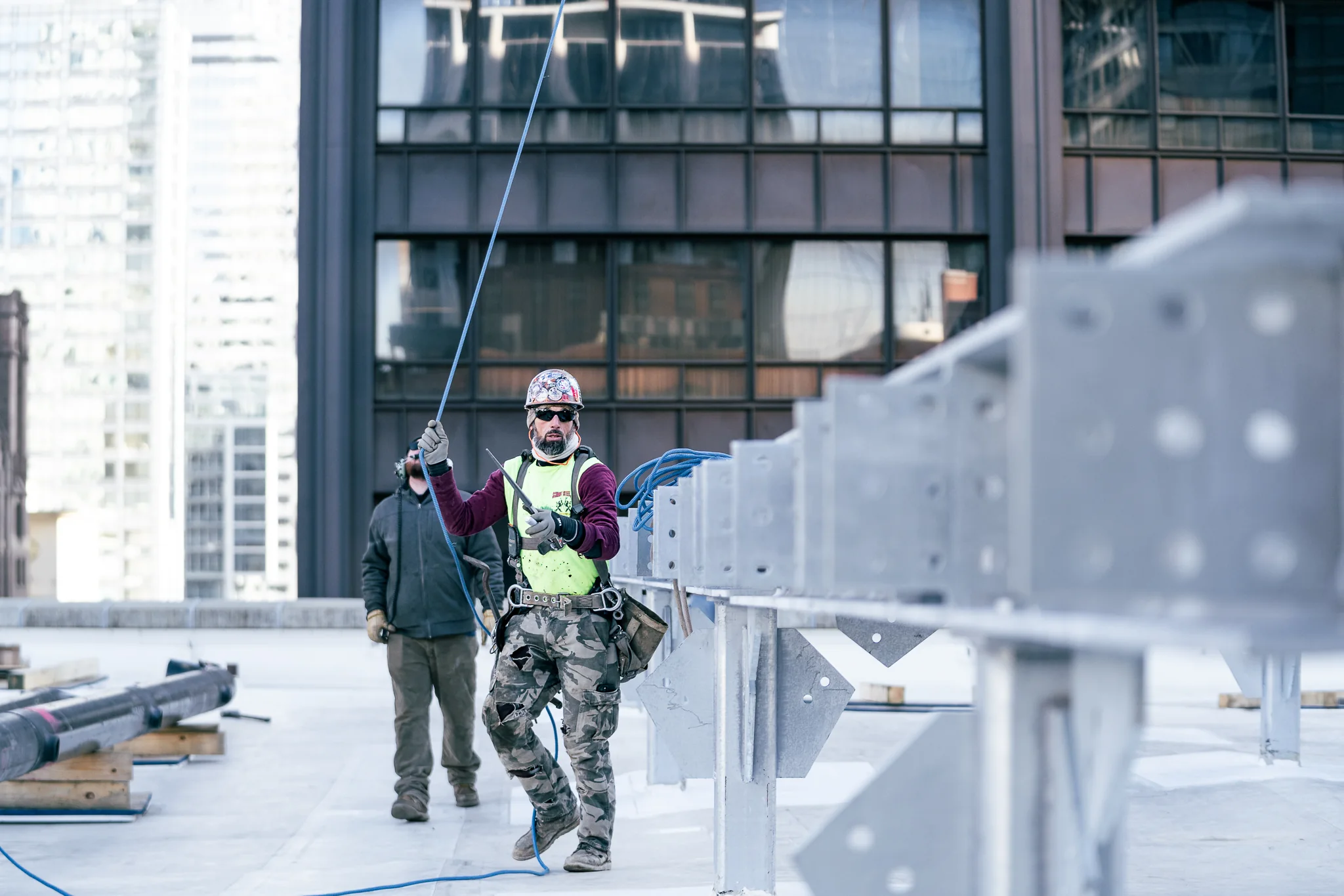 Ironworkers coordinating steel installation on a Chicago rooftop